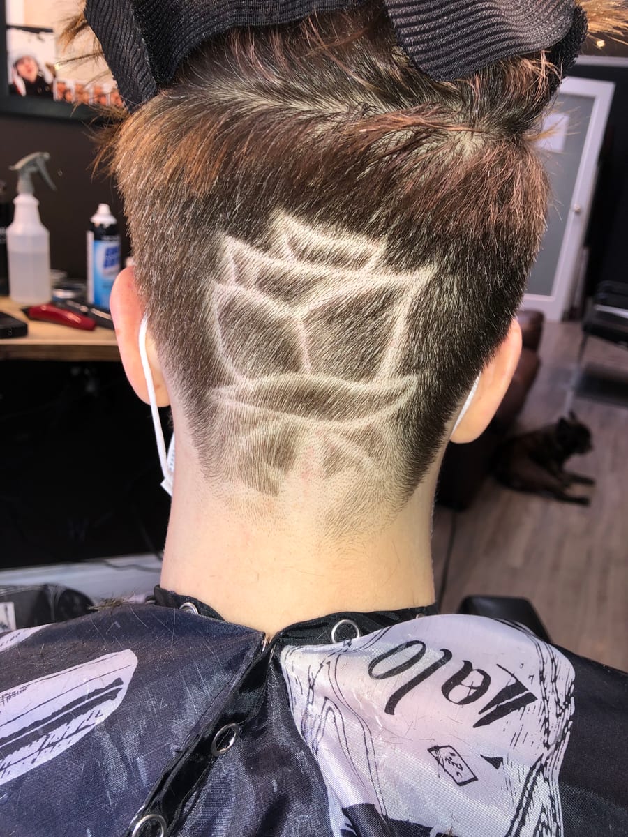 A geometric design shaved into the back of a client's head